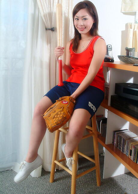 Hot oriental brunette young Yumi in fancy shorts exhibits her butt and loves dildo 